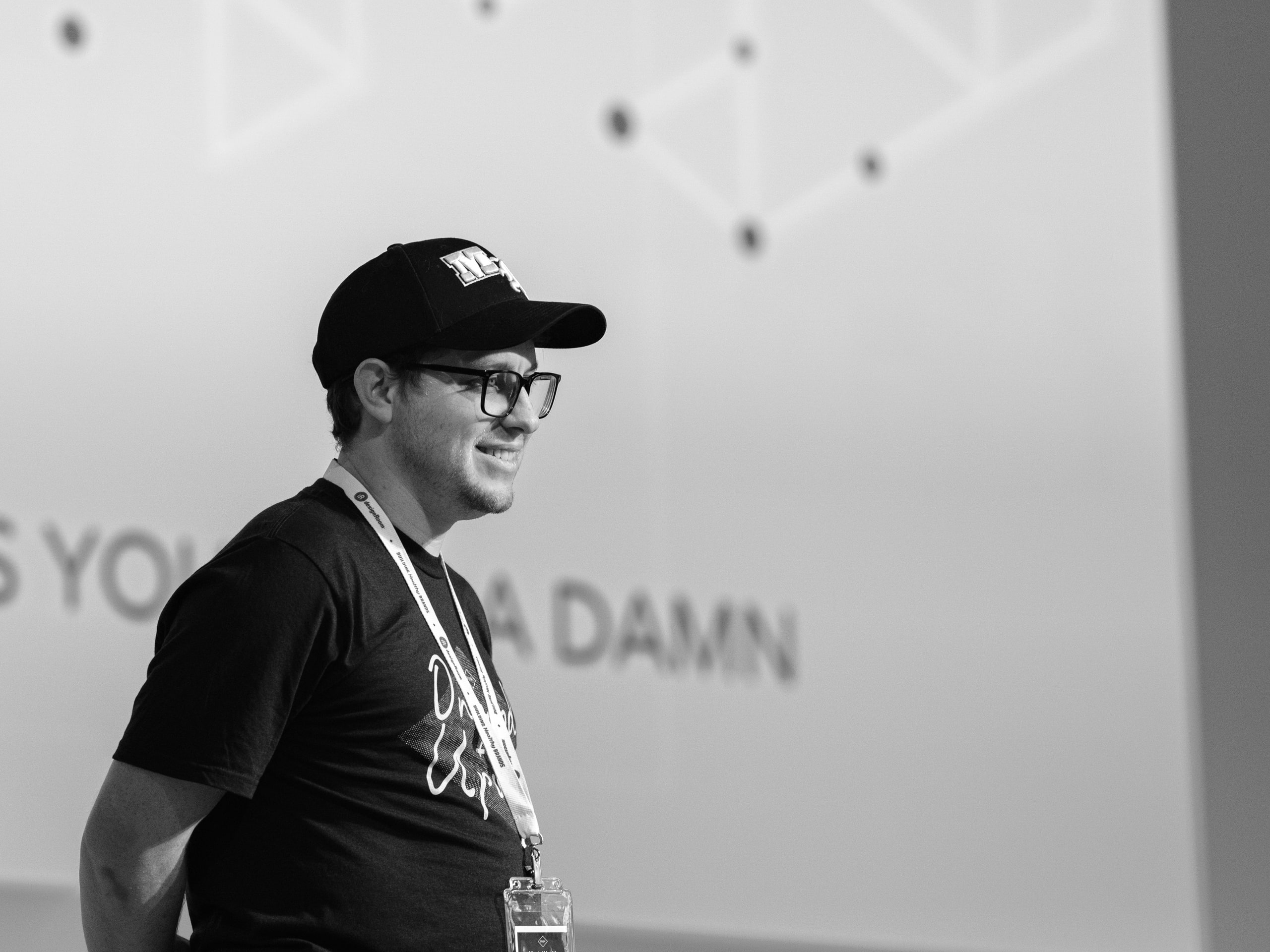 Speaker in the cap, GIVE A DAMN behind at a conference in Nashville.