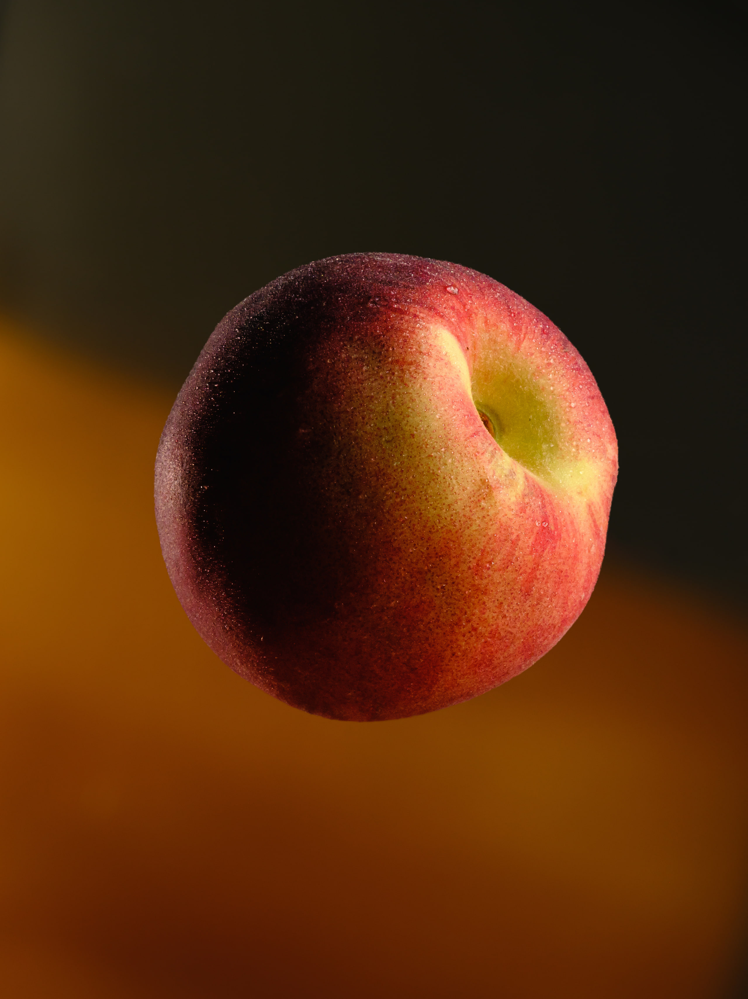 Peach on dark, single object floating.