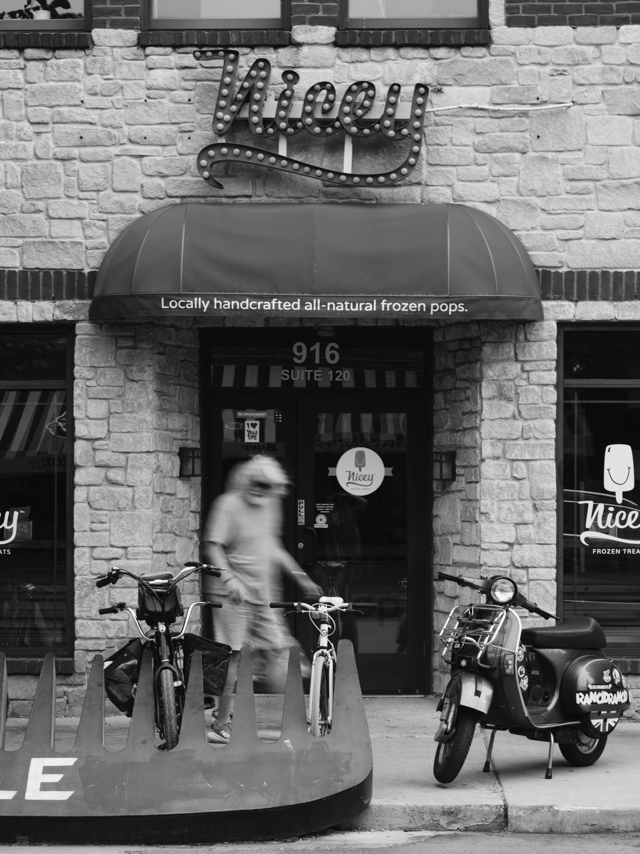 B&w Tiger storefront, sign and shadow.