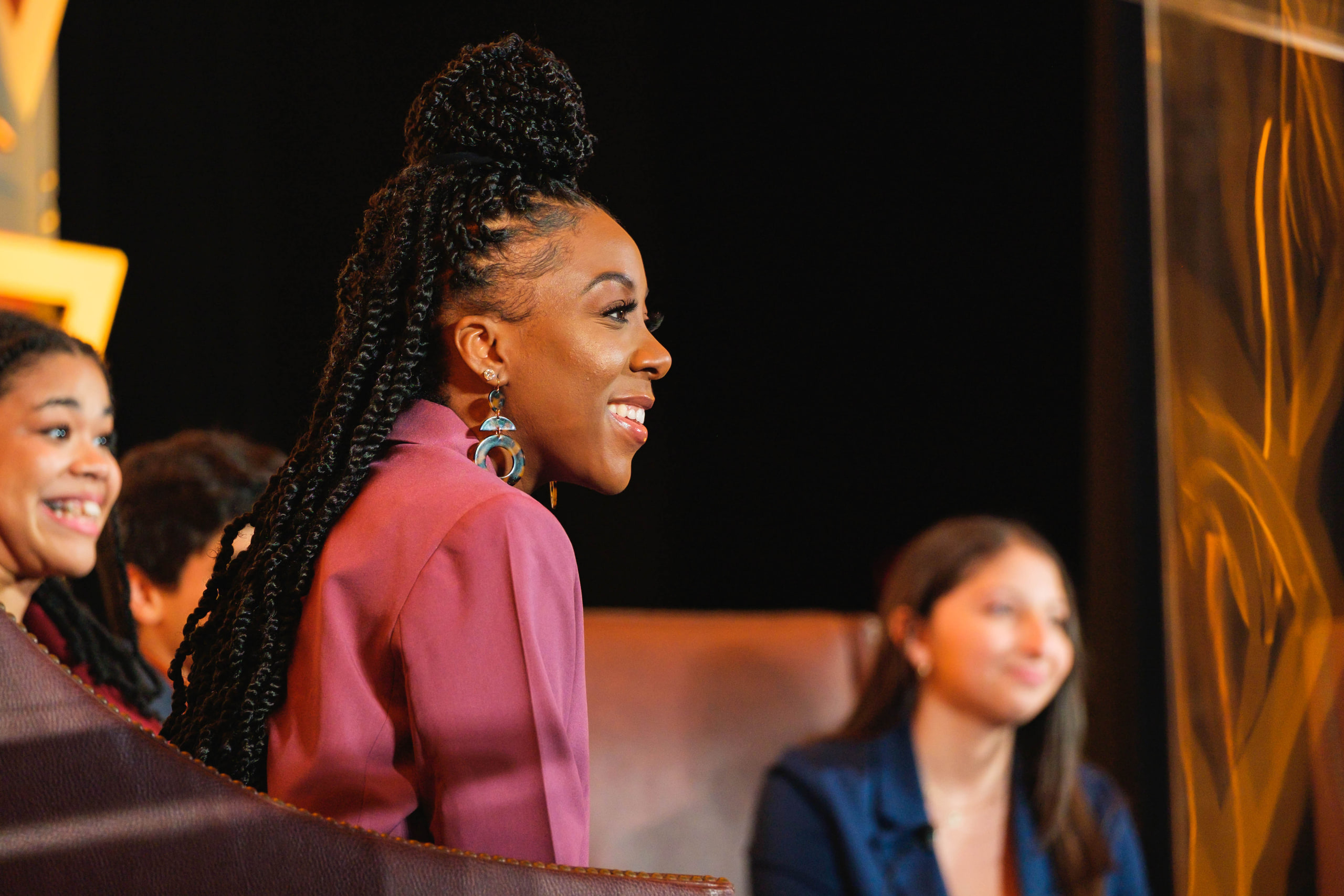 Braids and magenta, laughing on the panel at a national summit afternoon plenary.
