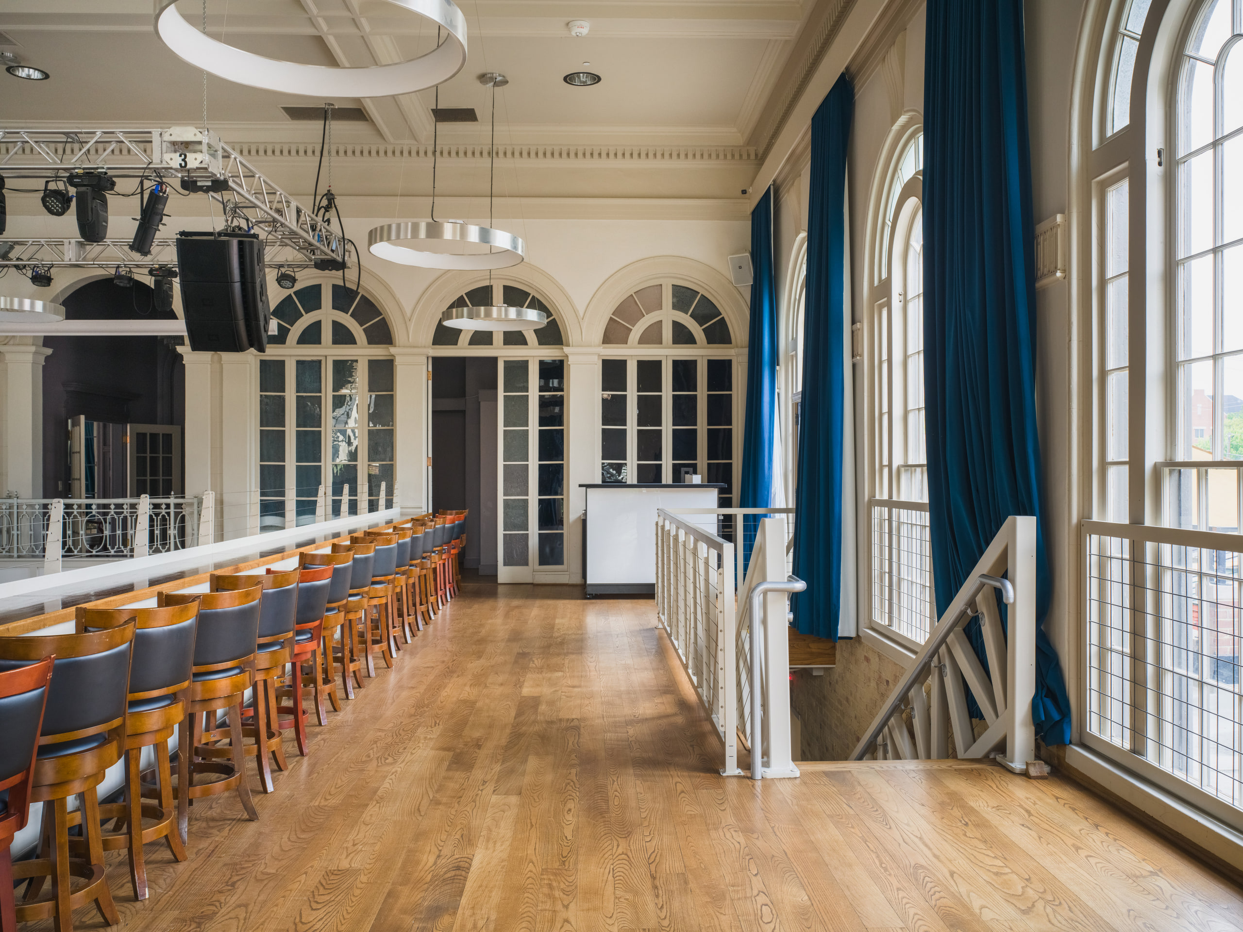 The bar under the blue drapes and arched windows.