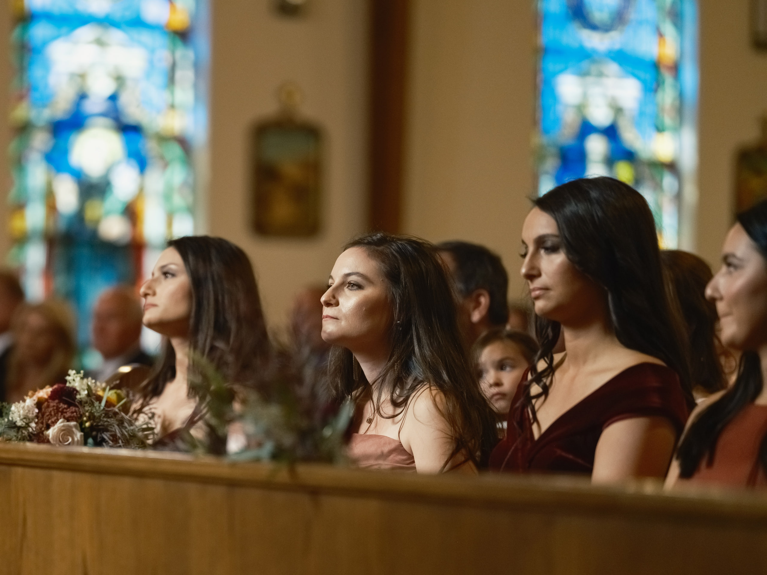 Stained glass and guests, color thrown across.