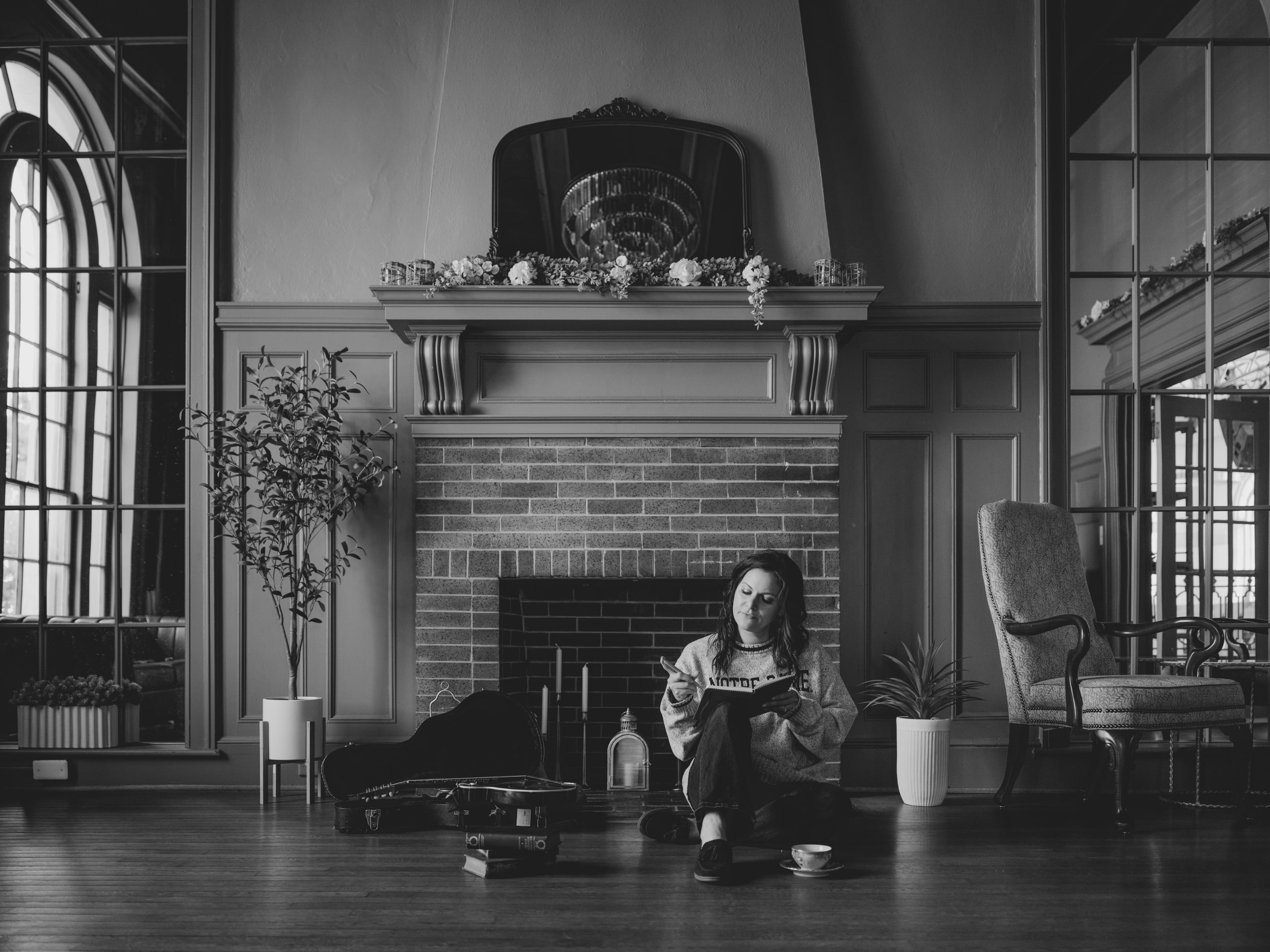 B&w hall with fireplace and arched windows, the room itself.