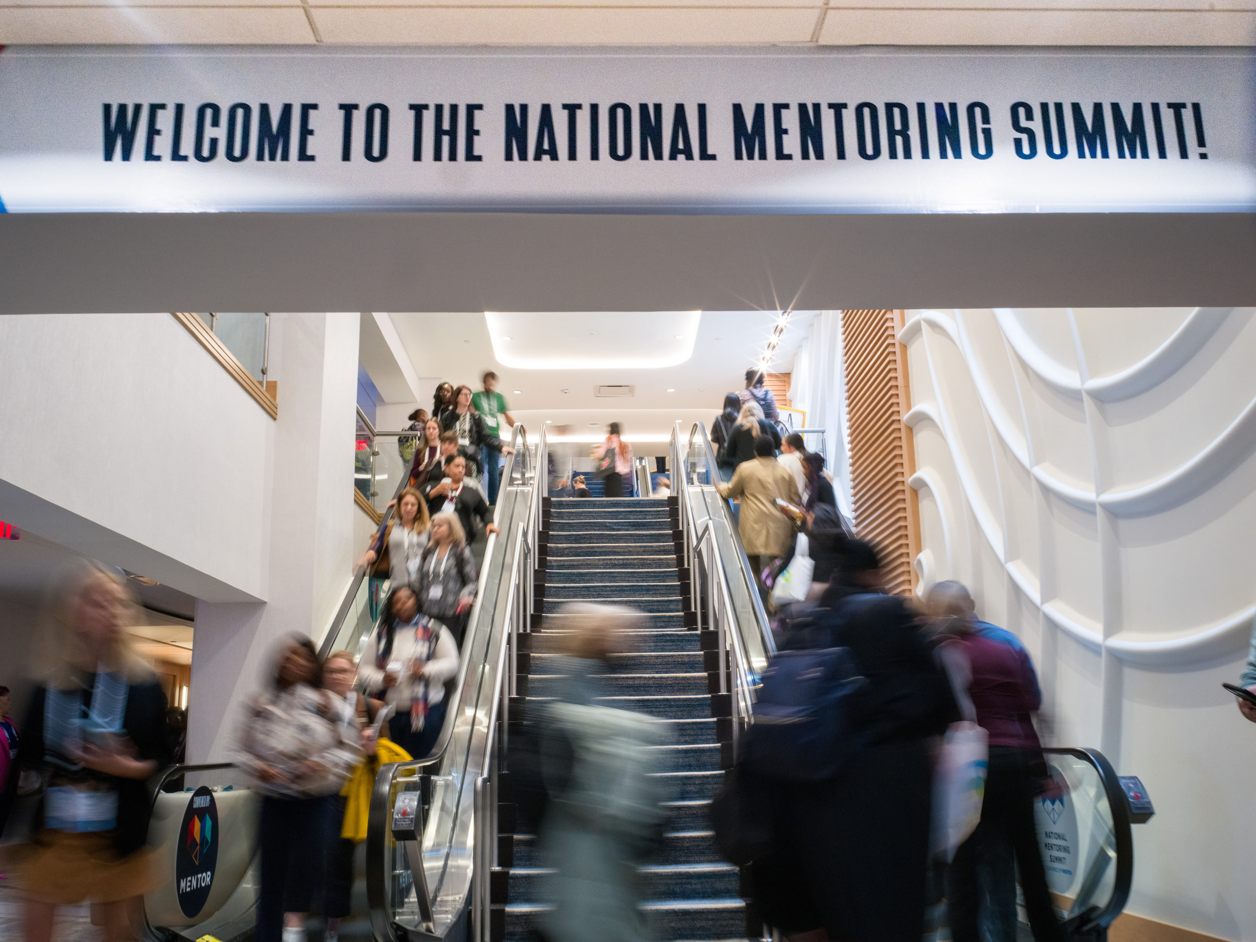 Escalator under the summit banner, arrival.