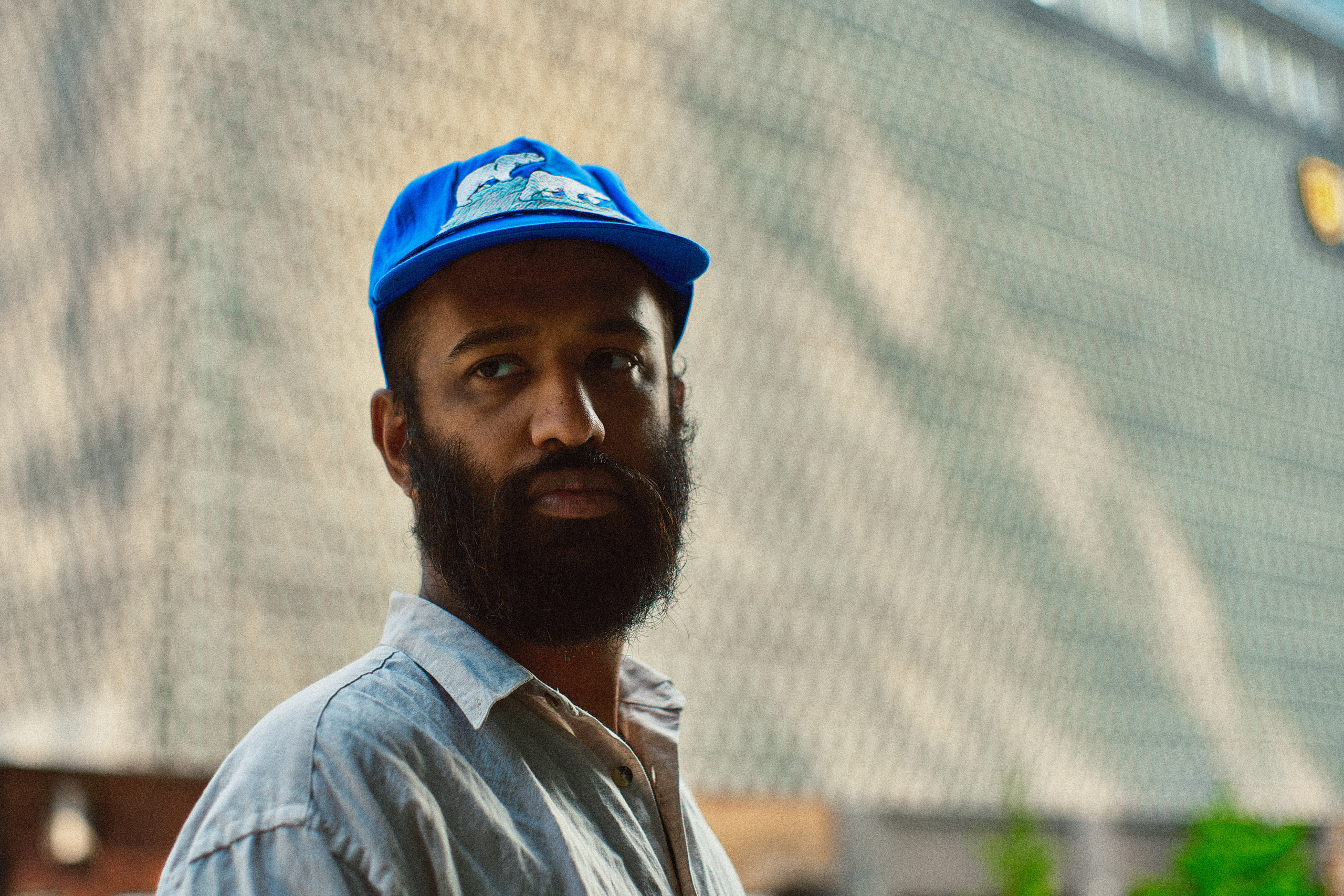 Blue cap, direct, chain-link shadow in downtown Nashville.