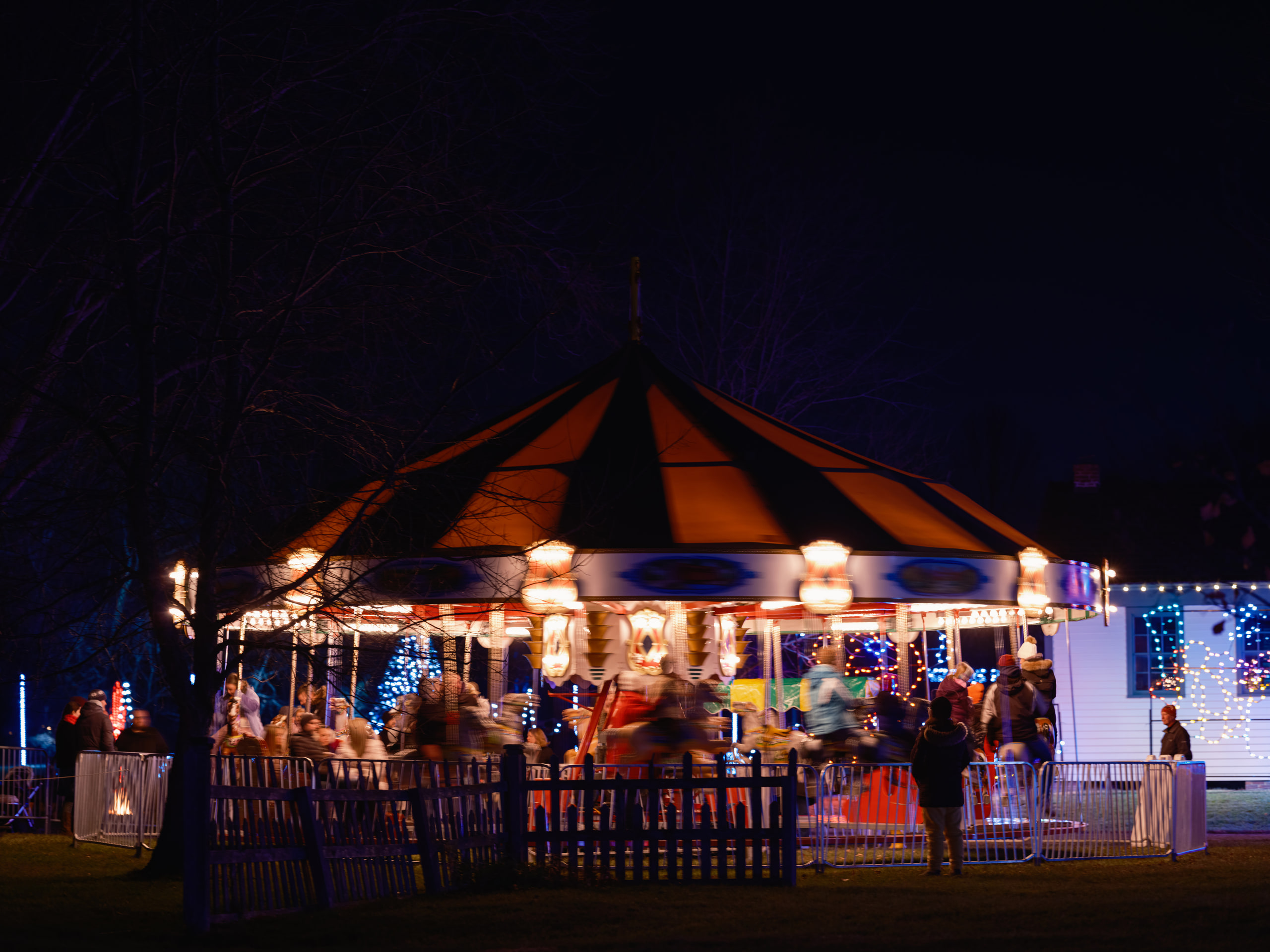 Lit pavilion at night, crowd.