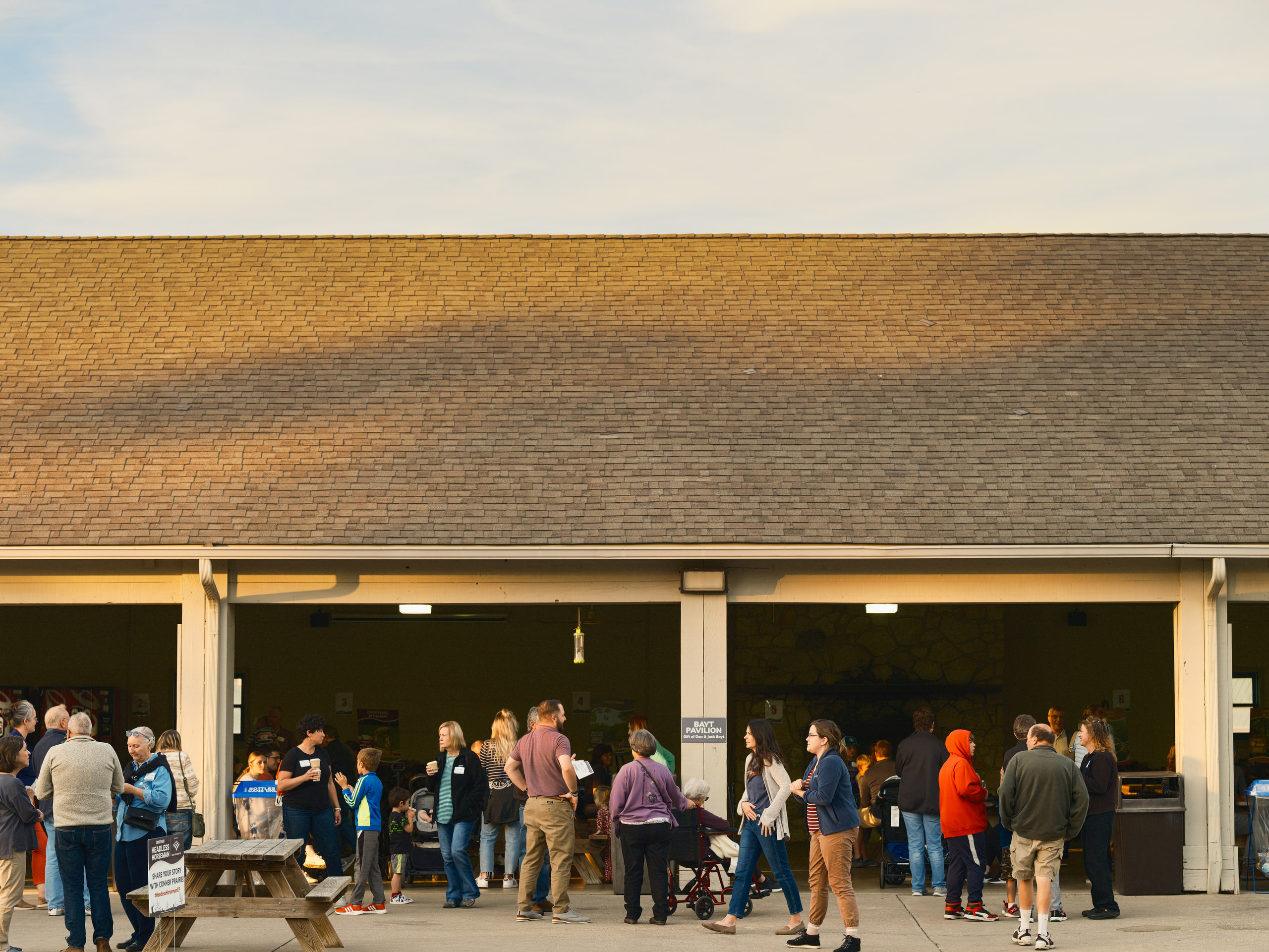 Crowd under the pavilion at dusk, the event working.