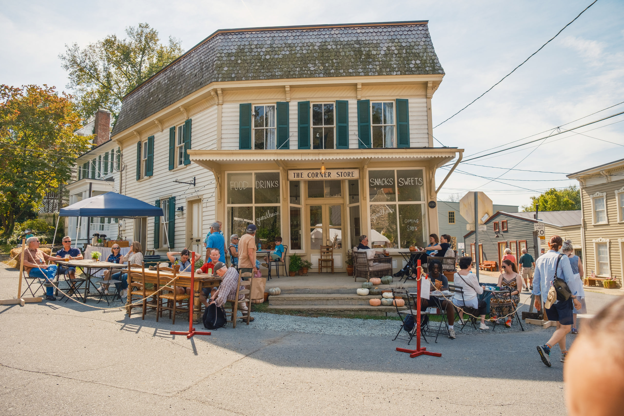 The Corner Store on the village street in Waterford, Virginia, with people at tables outside during the Fair.