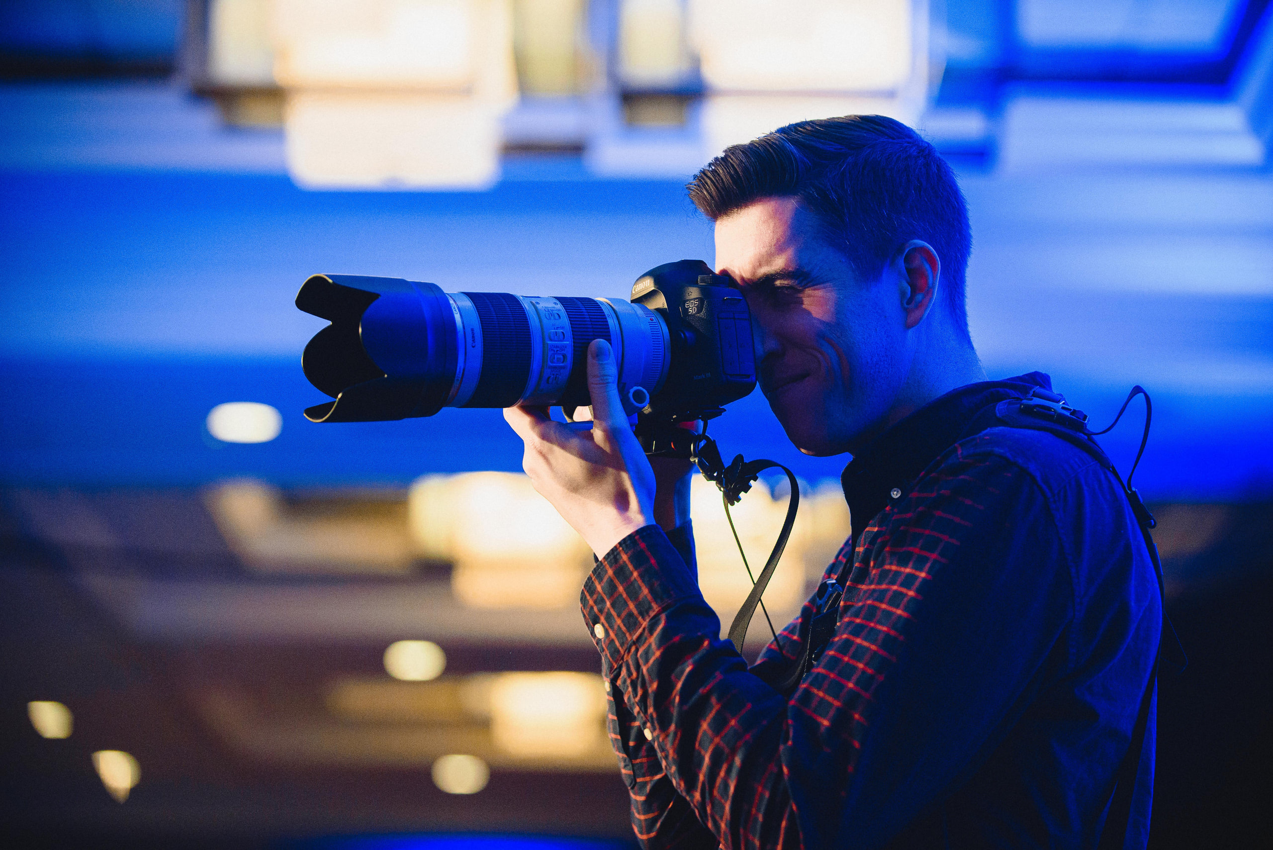 Photographer with the long lens, portrait at a conference in Washington, DC.