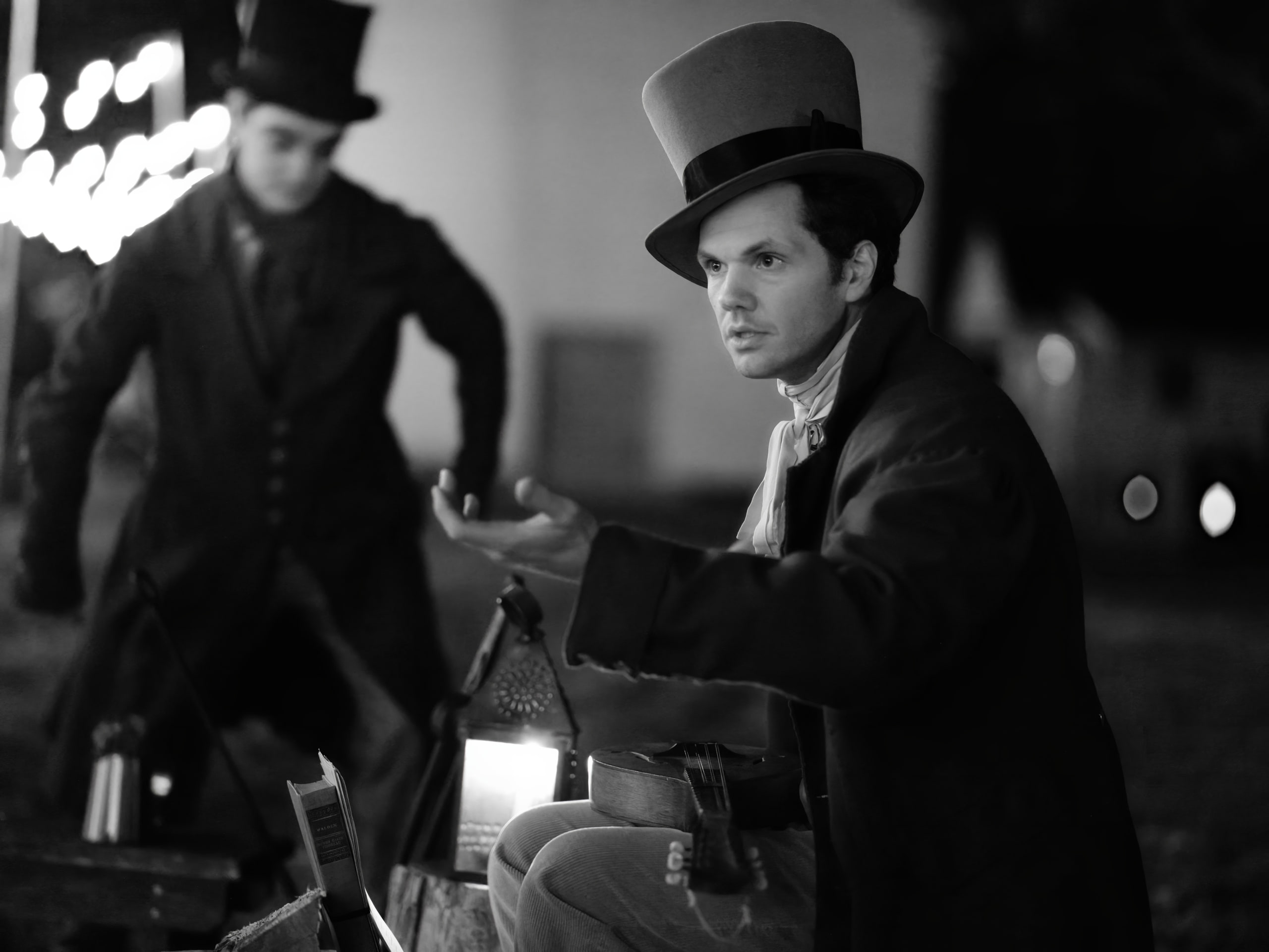 Black and white top hats and the lantern at a community event.