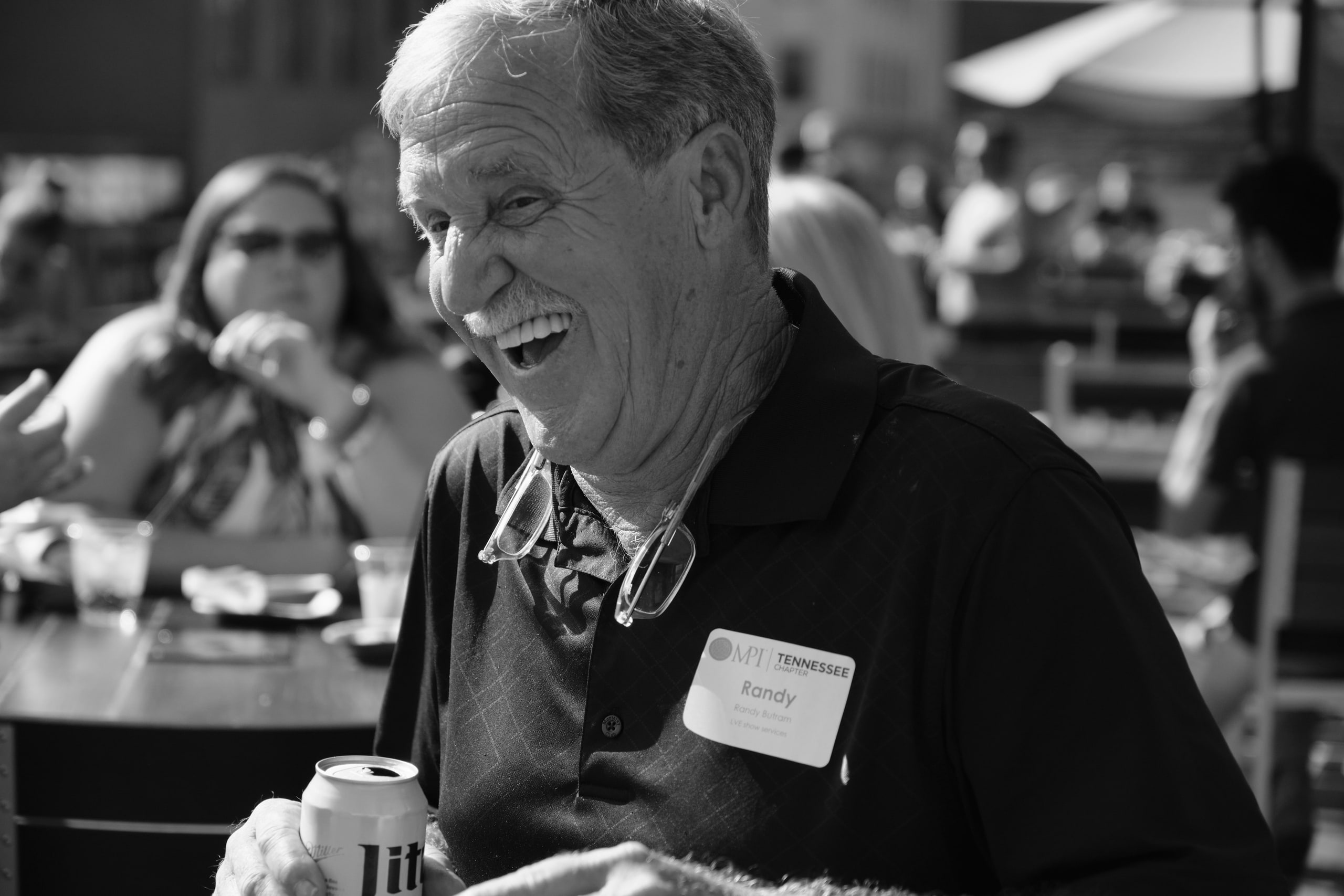 Man laughing, rooftop at a rooftop industry mixer, Nashville.