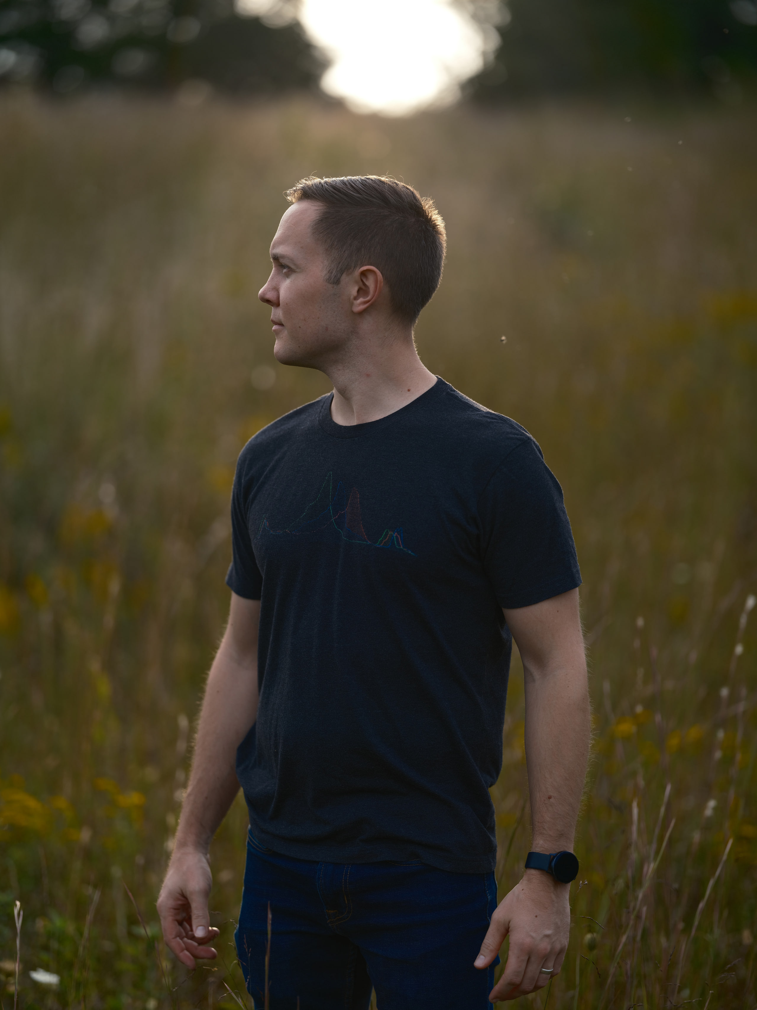 Standing in a field, environmental portrait.