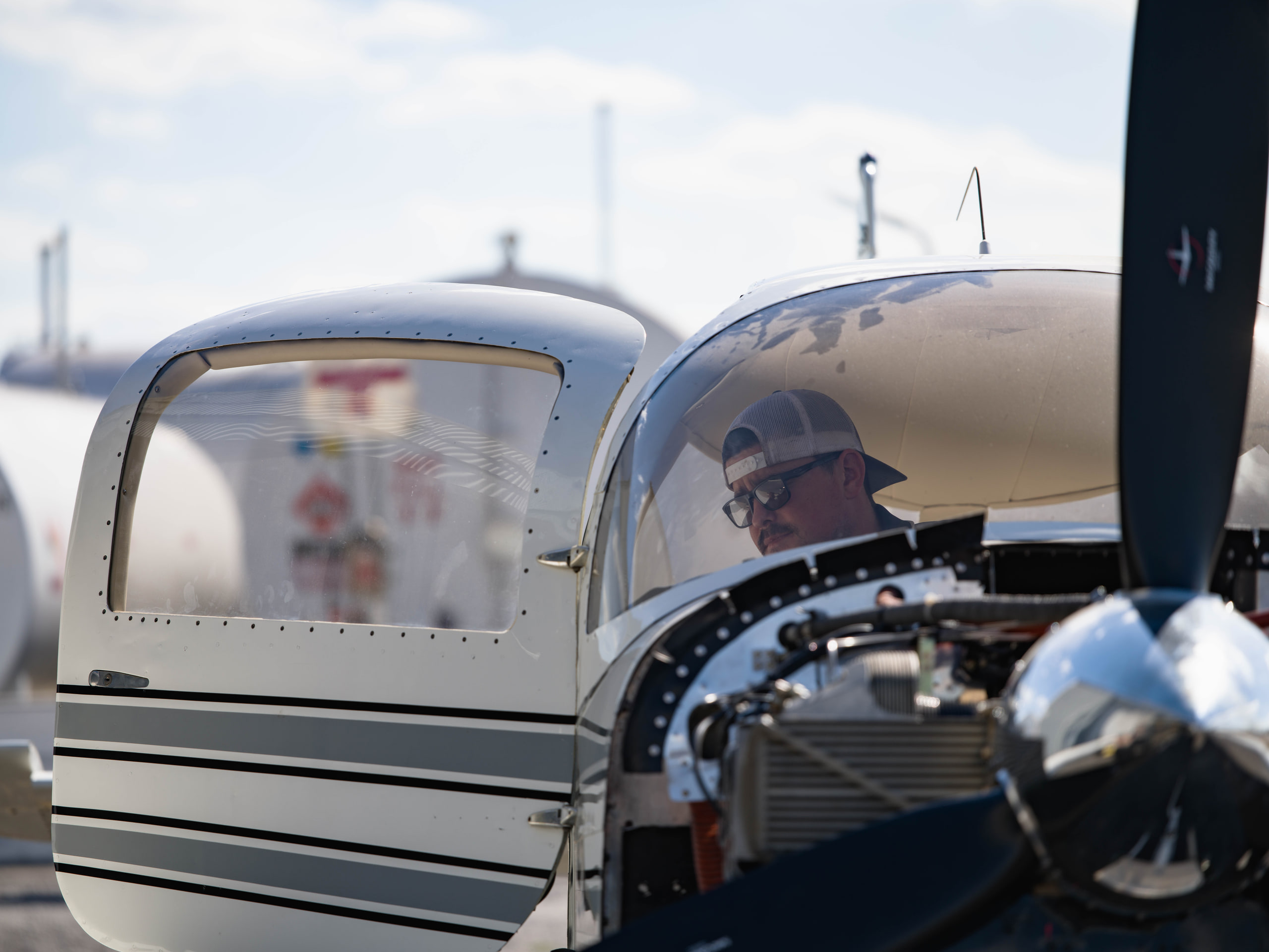 Man walking with the plane, wide at an aviation maintenance company.