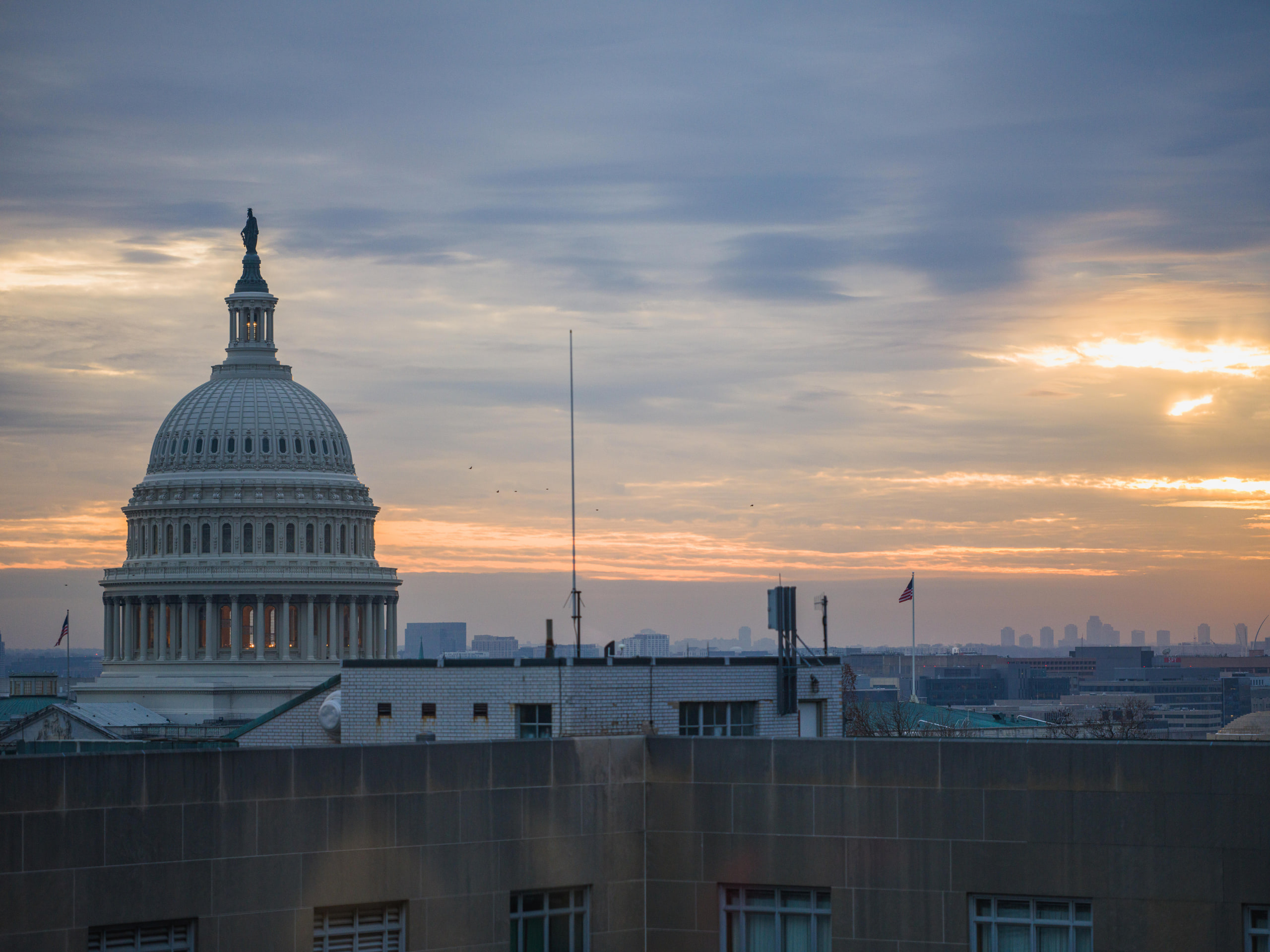 The United States Capitol dome at sunset, seen from a reception on Capitol Hill