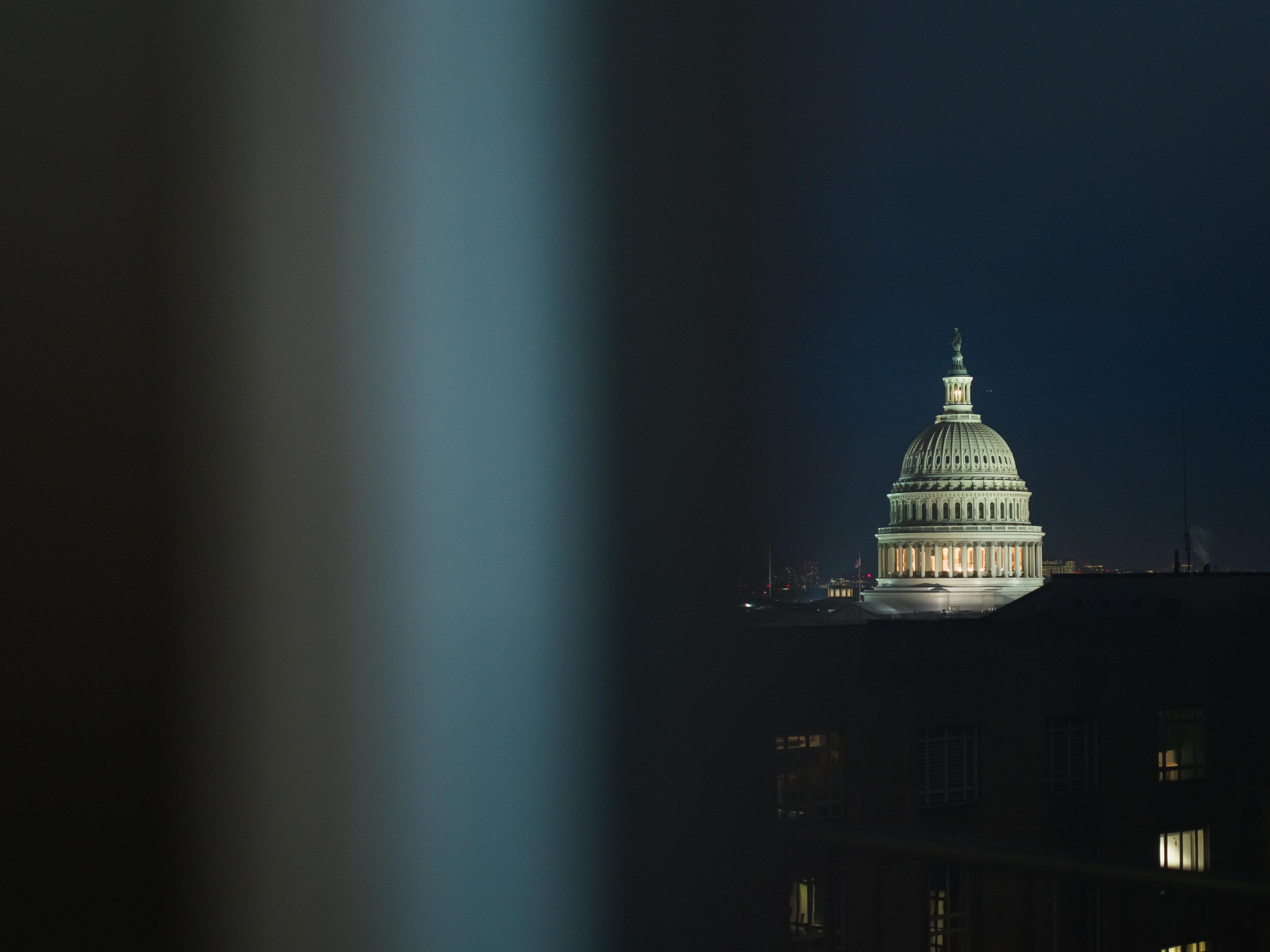 Capitol dome at night between columns, abstract at the Capitol Hill reception in Washington, DC.