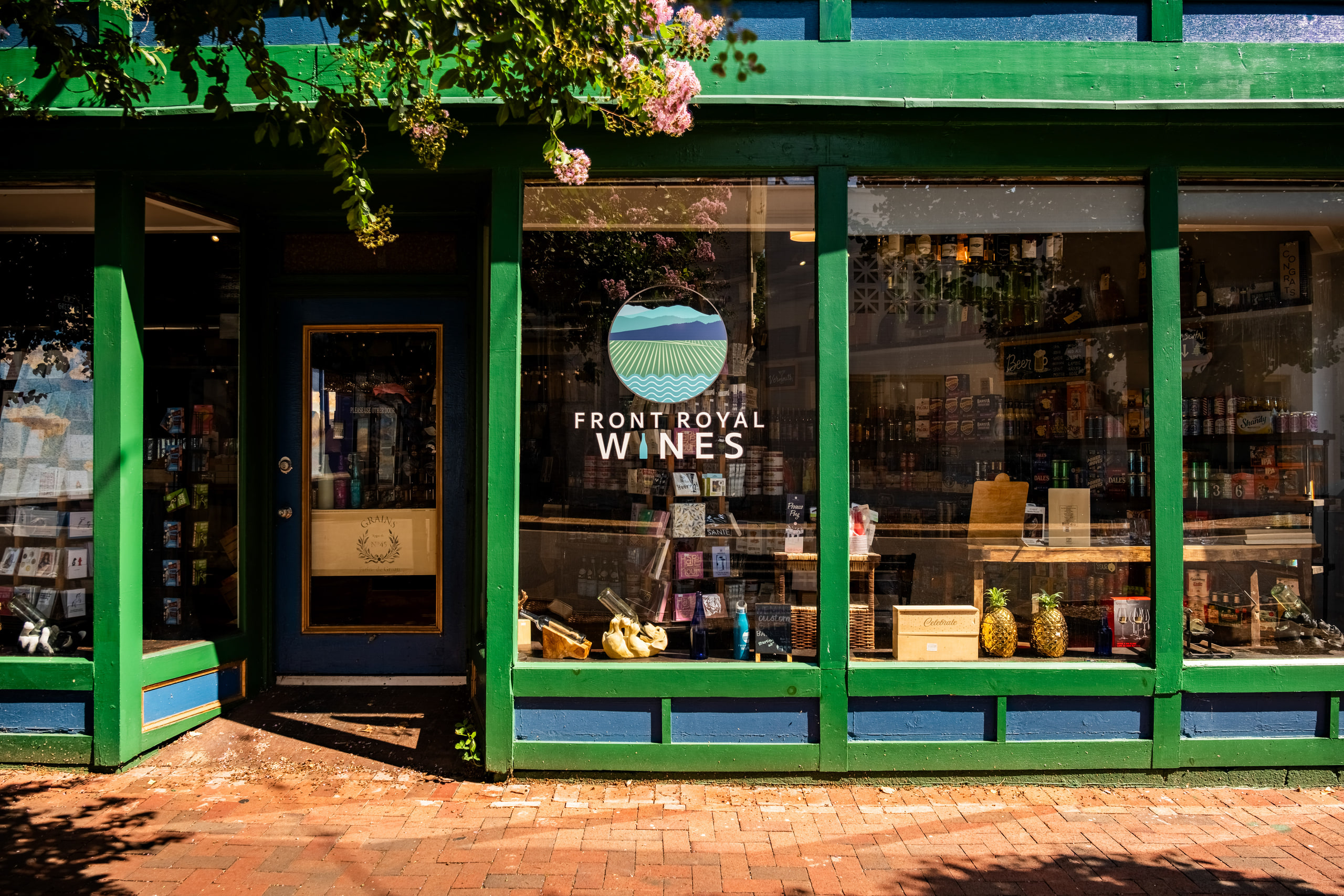 Storefront, green awnings, signage.